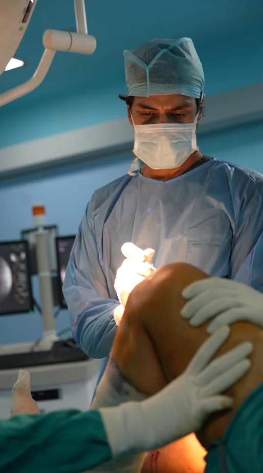 Dr. Manu Bora examining a patient's knee