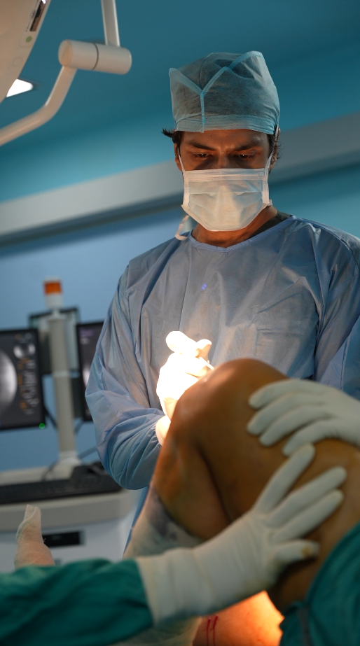 Dr. Manu Bora examining a knee in the operating theatre