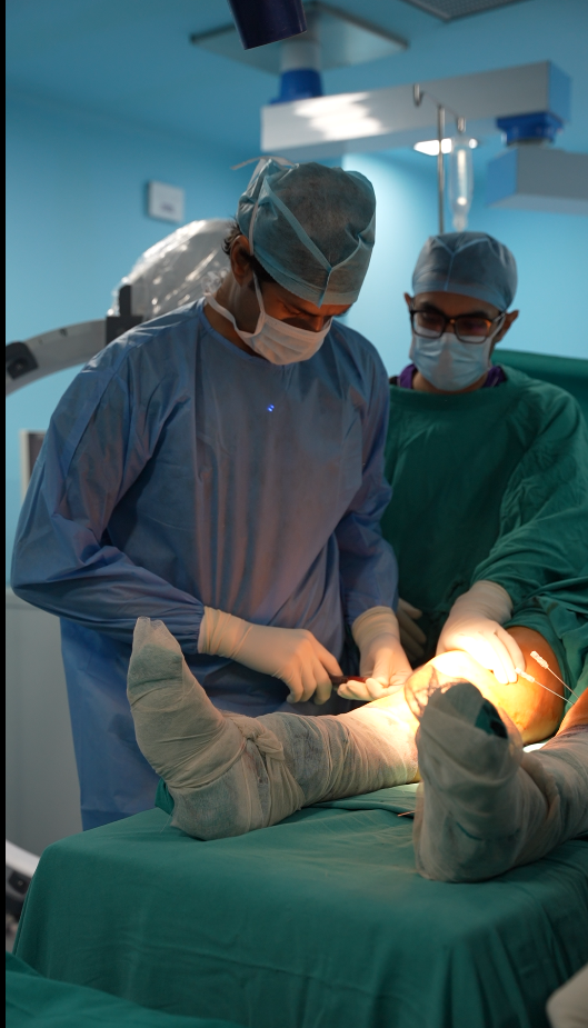 Dr. Manu Bora performing a knee procedure with his team